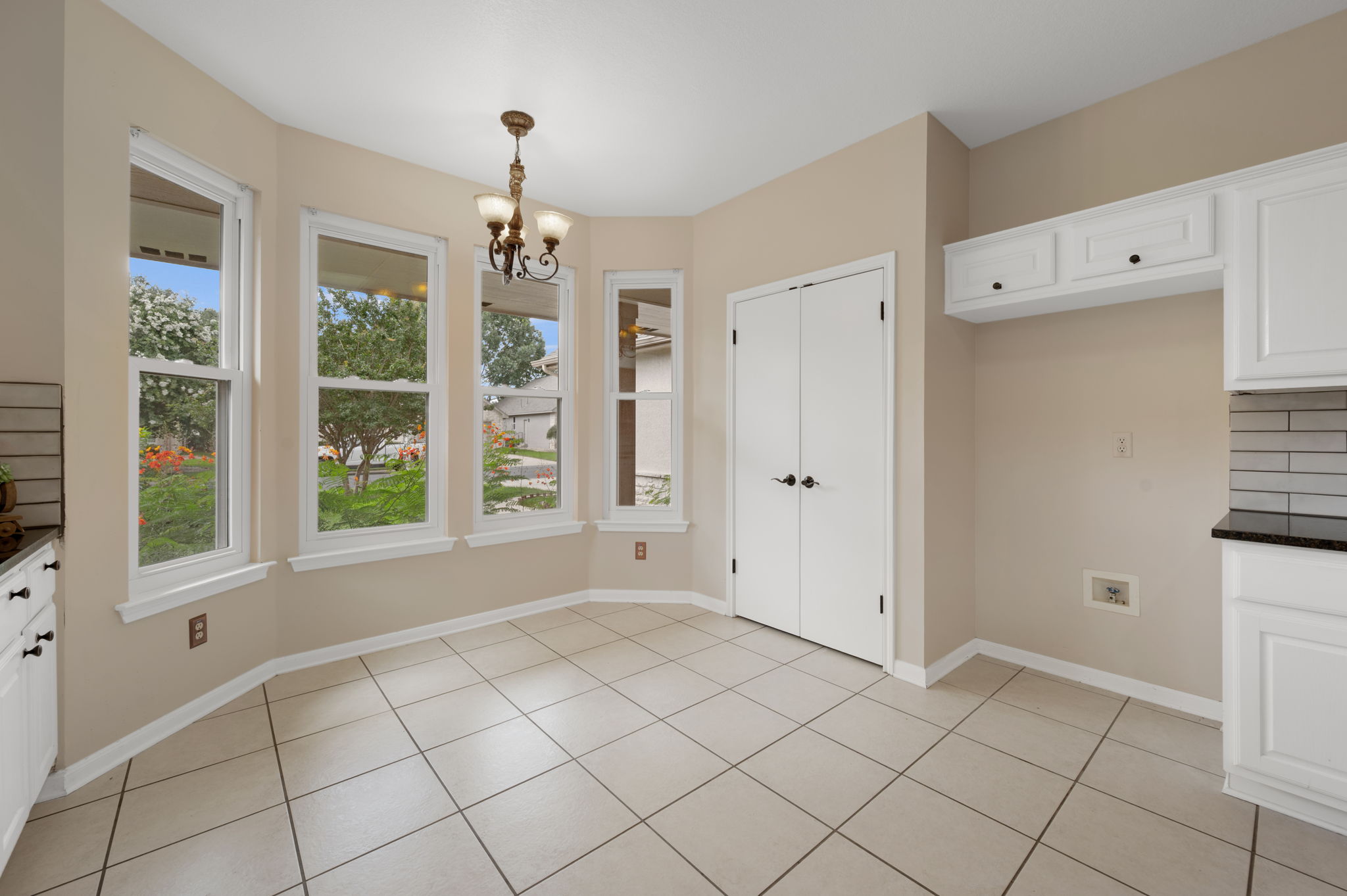118 Bass Street Georgetown, TX 78633 - Photo 20 of 40 A well-lit breakfast nook offers views of the verdant yard through multiple windows.