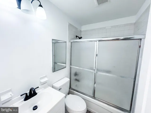 a white toilet sitting next to a bathroom sink