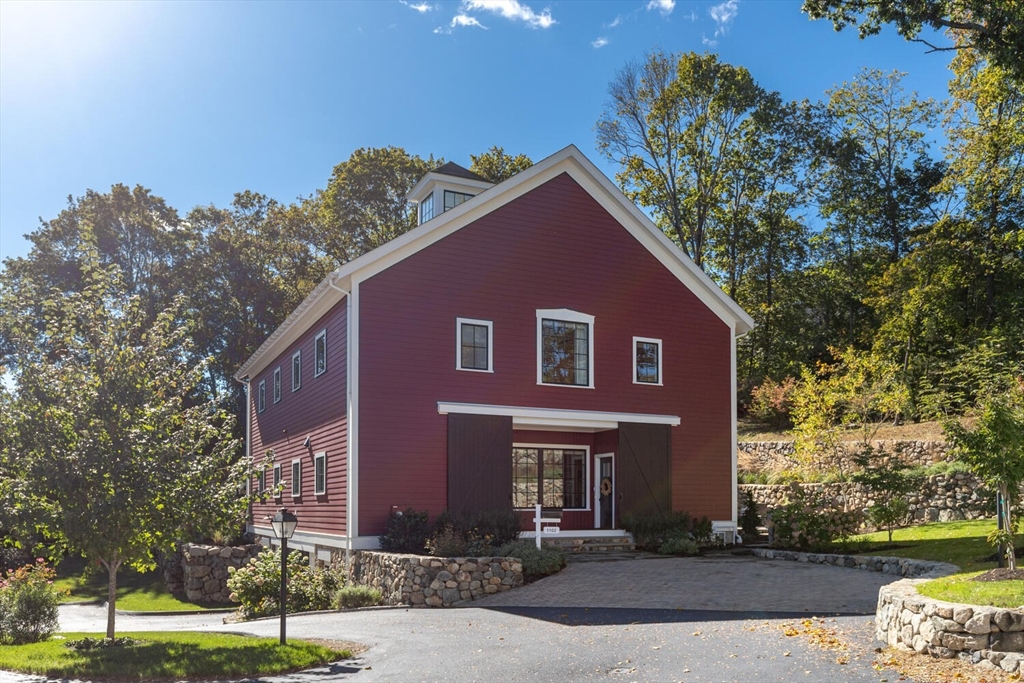 a front view of a house with yard and trees