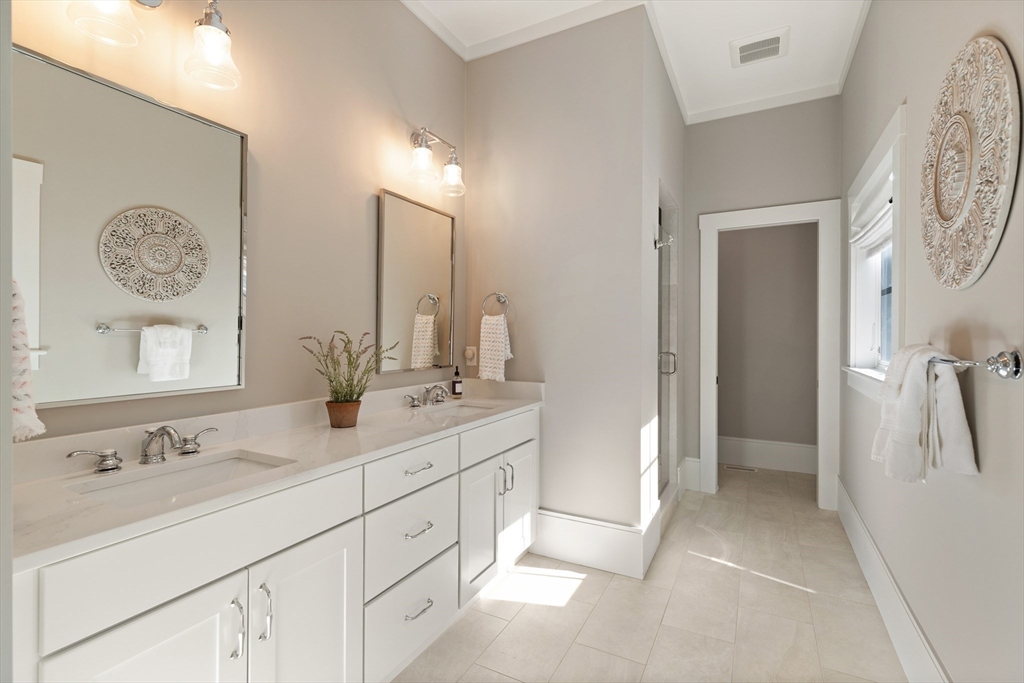 1102 Massachusetts Avenue Lexington, MA 02421 - Photo 19 of 42 a bathroom with double vanity sink and a mirror