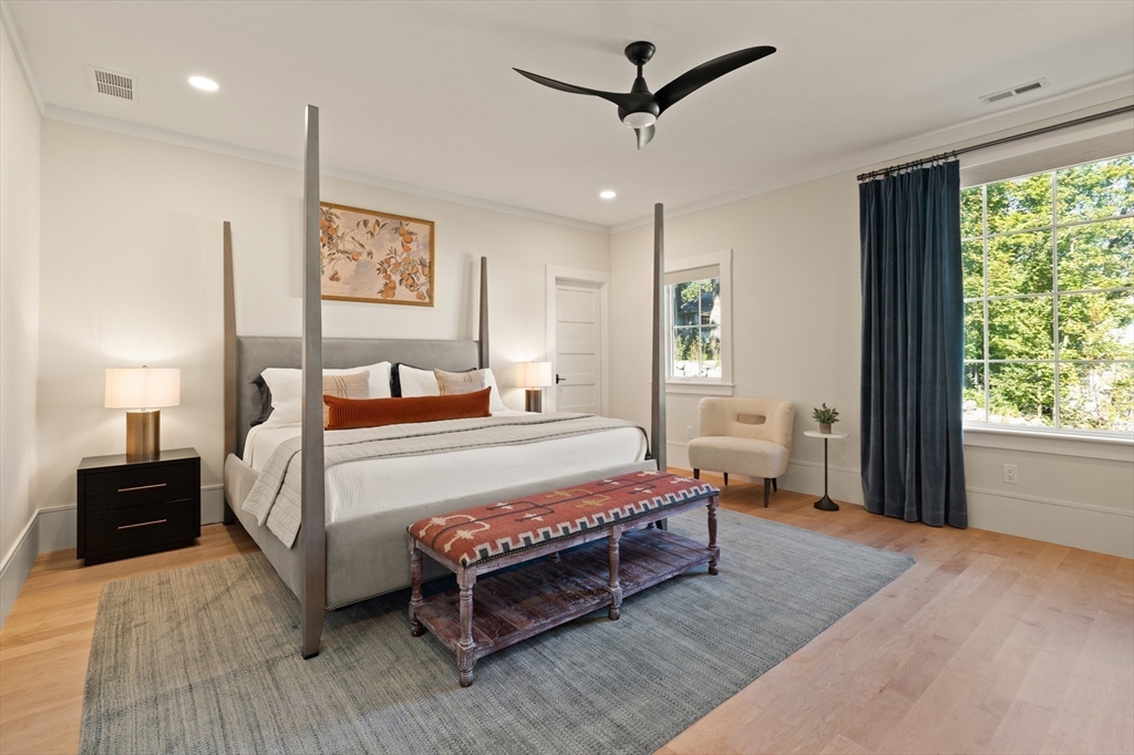 1102 Massachusetts Avenue Lexington, MA 02421 - Photo 22 of 42 a bedroom with a bed lamp and a window