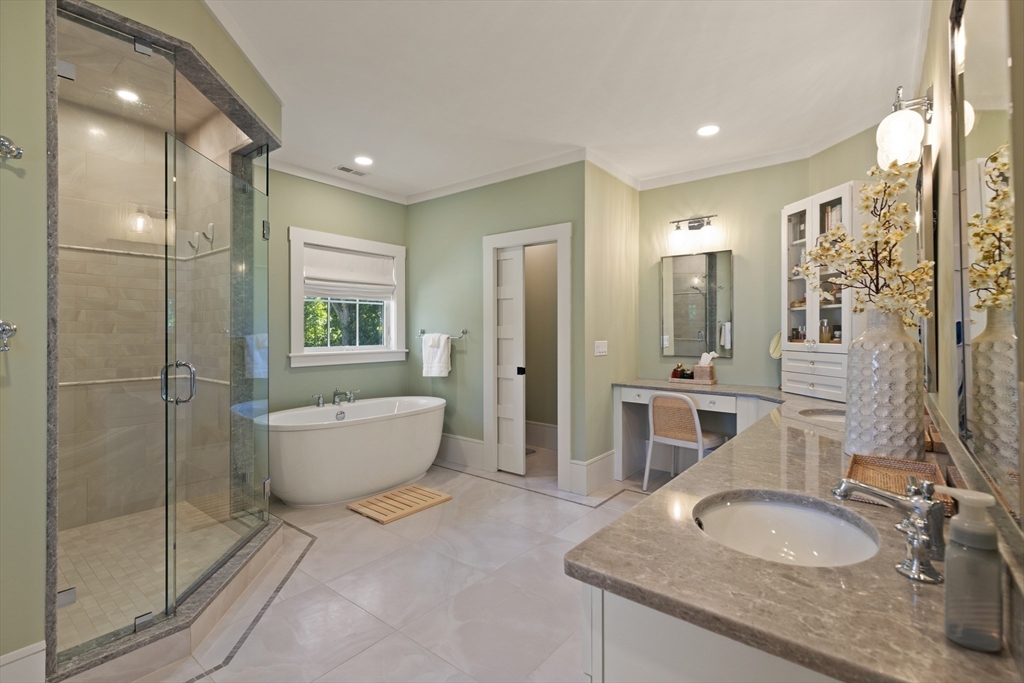 1102 Massachusetts Avenue Lexington, MA 02421 - Photo 23 of 42 a bathroom with a granite countertop sink a toilet a mirror and shower