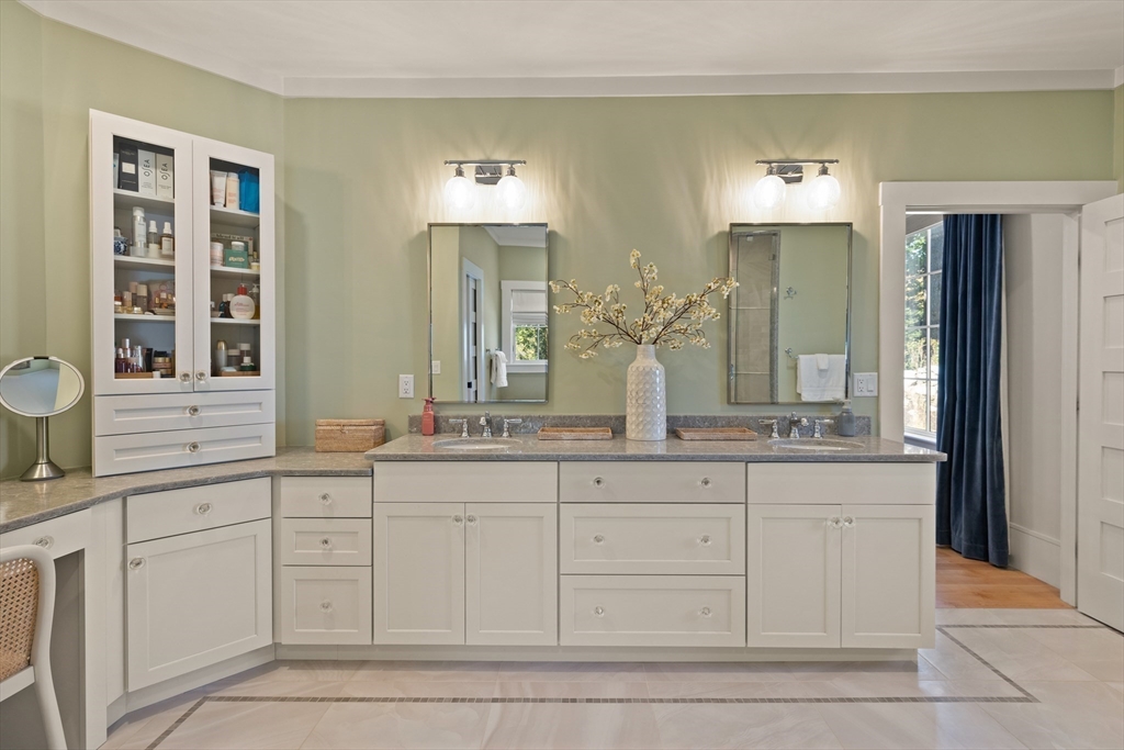 1102 Massachusetts Avenue Lexington, MA 02421 - Photo 24 of 42 a bathroom with white cabinets and a sink