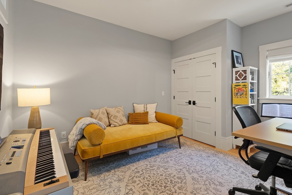 1102 Massachusetts Avenue Lexington, MA 02421 - Photo 27 of 42 a living room with furniture and a wooden floor