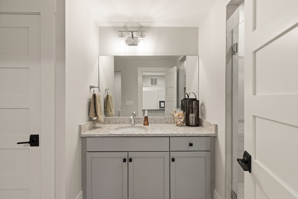 1102 Massachusetts Avenue Lexington, MA 02421 - Photo 28 of 42 a bathroom with a sink and a mirror