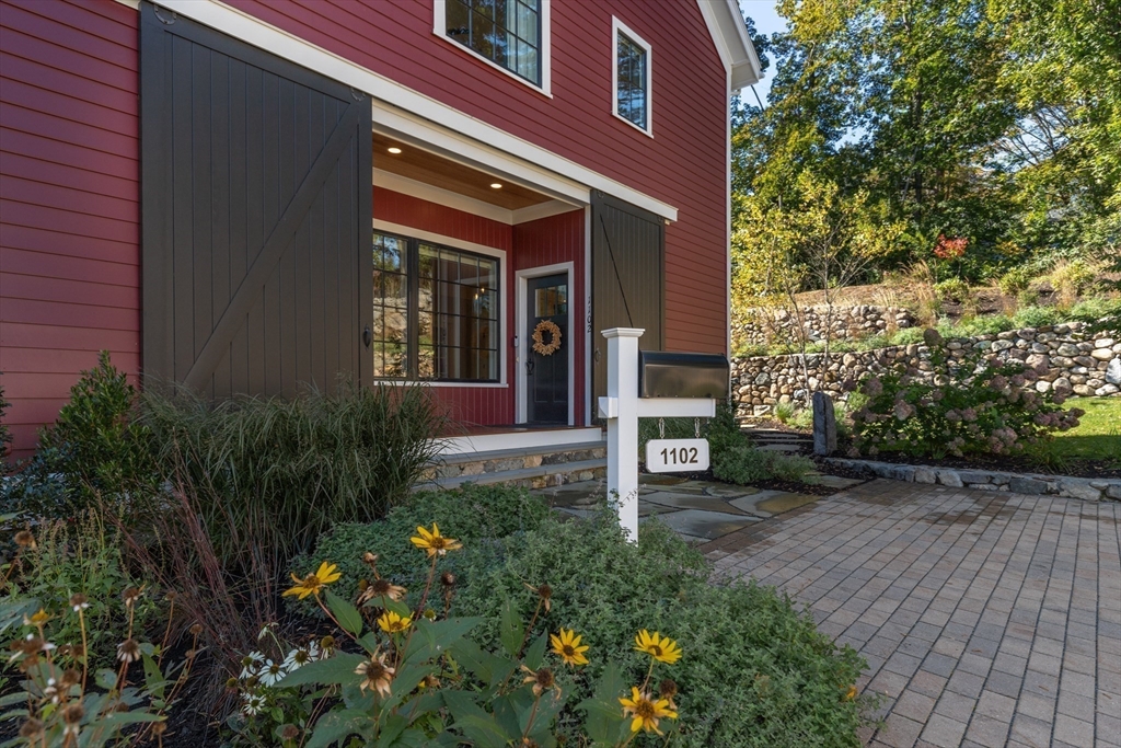 1102 Massachusetts Avenue Lexington, MA 02421 - Photo 3 of 42 a view of a house with a small yard and plants