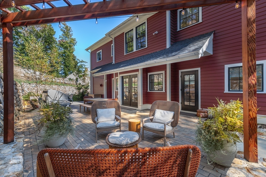 1102 Massachusetts Avenue Lexington, MA 02421 - Photo 35 of 42 a view of a patio with couches chairs dining table and chairs