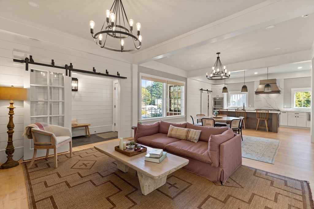 1102 Massachusetts Avenue Lexington, MA 02421 - Photo 4 of 42 a living room with furniture and a chandelier