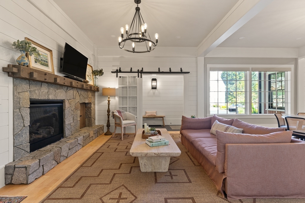 1102 Massachusetts Avenue Lexington, MA 02421 - Photo 5 of 42 a living room with furniture a fireplace and a flat screen tv