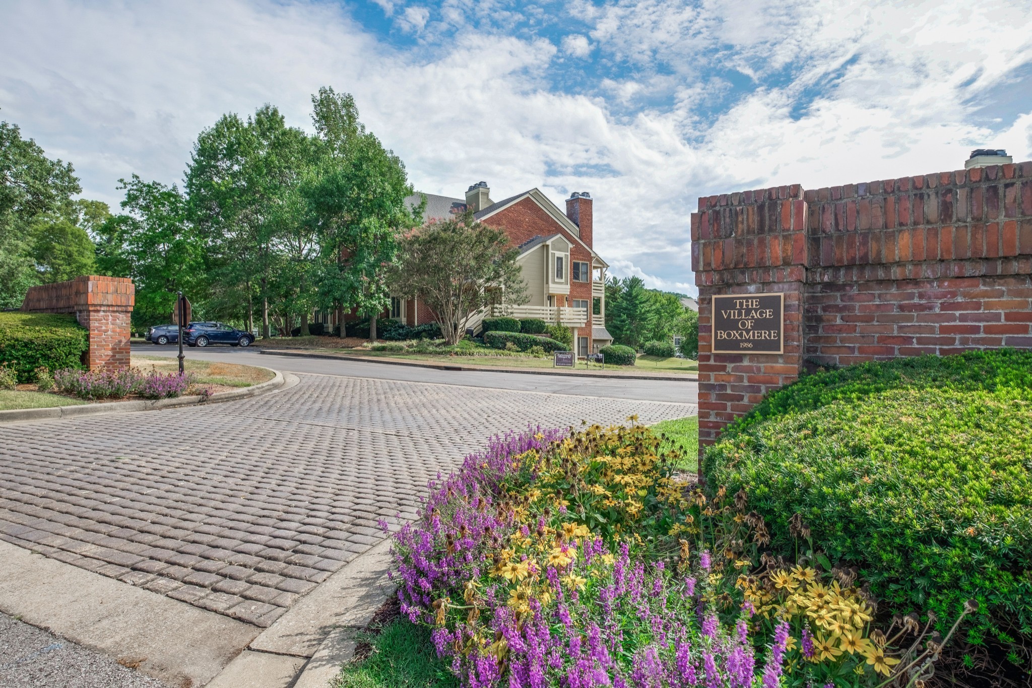 a sign board with buildings in the background