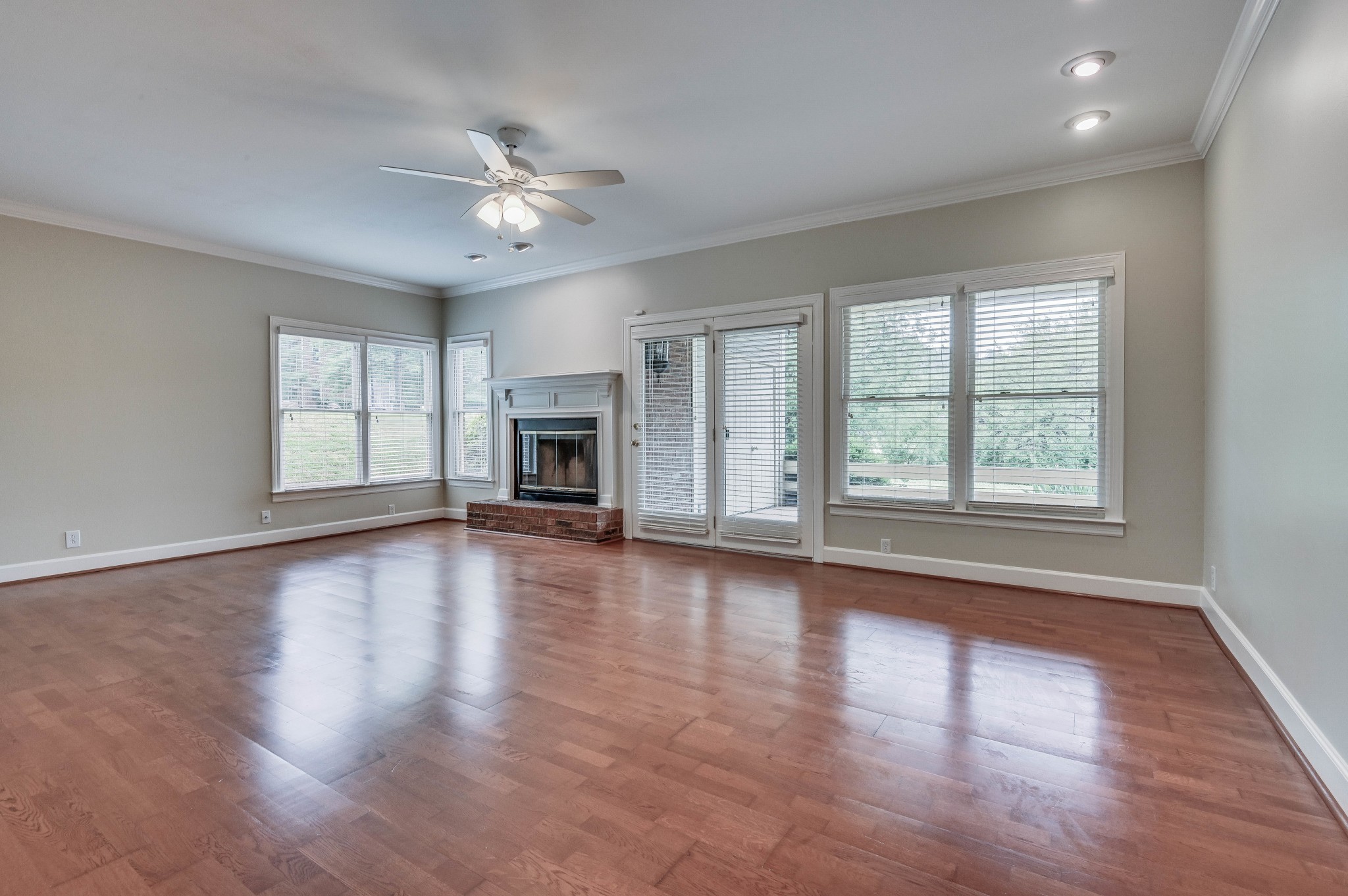 301 Boxmere Place Nashville, TN 37215 - Photo 19 of 40 an empty room with wooden floor chandelier and windows