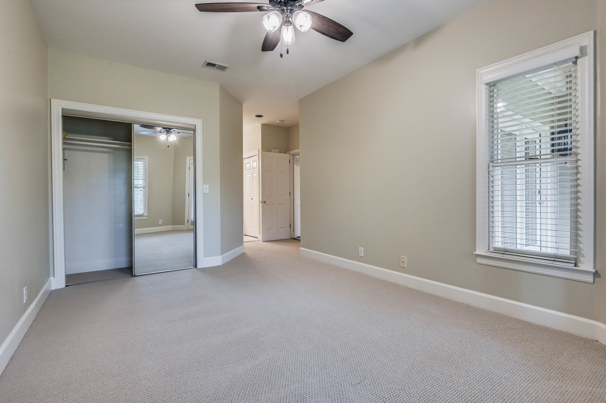 301 Boxmere Place Nashville, TN 37215 - Photo 20 of 40 an empty room with chandelier fan and windows