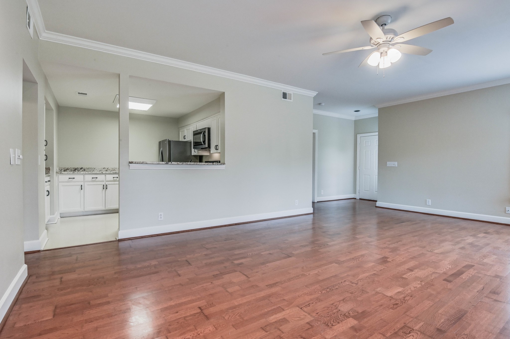 301 Boxmere Place Nashville, TN 37215 - Photo 29 of 40 a view of a kitchen with a kitchen island wooden floor and a ceiling fan