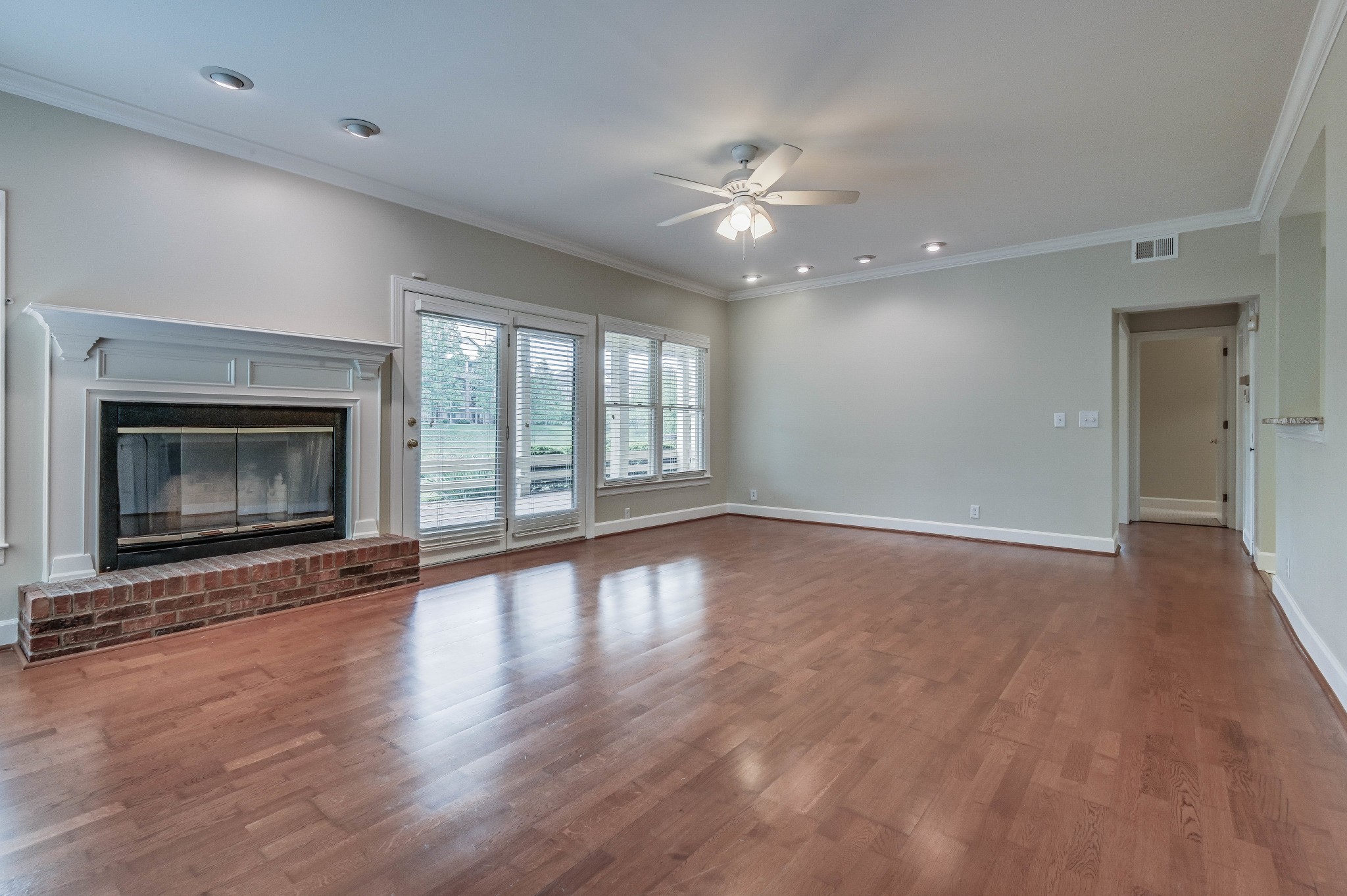301 Boxmere Place Nashville, TN 37215 - Photo 30 of 40 a view of an empty room with wooden floor fireplace and a window