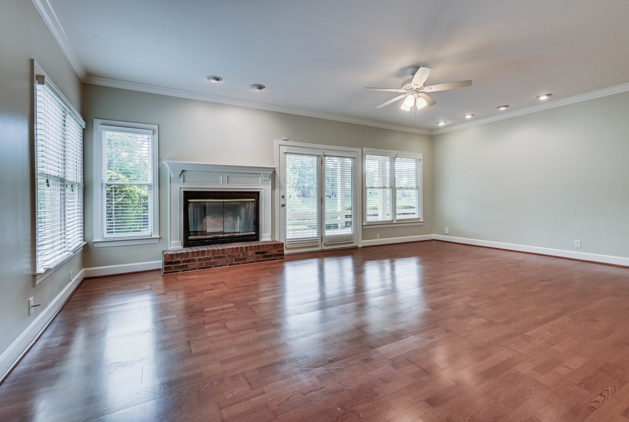301 Boxmere Place Nashville, TN 37215 - Photo 39 of 40 an empty room with wooden floor fireplace and windows