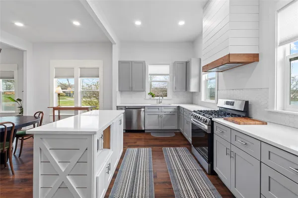 a kitchen with a refrigerator stove and sink