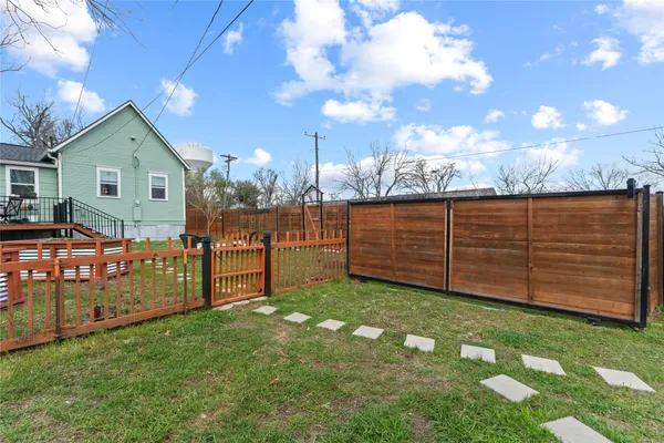 a backyard of a house with table and chairs