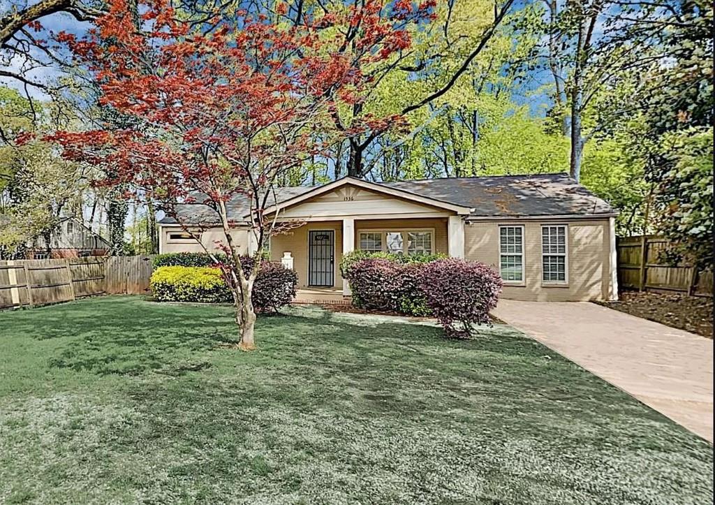 a front view of house with a garden
