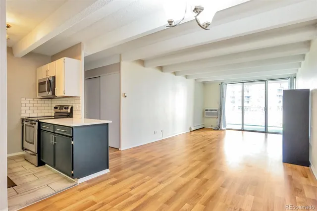 a kitchen with stainless steel appliances granite countertop a refrigerator and a stove top oven