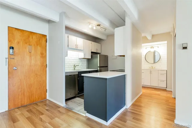 a kitchen with stainless steel appliances granite countertop a refrigerator and a stove