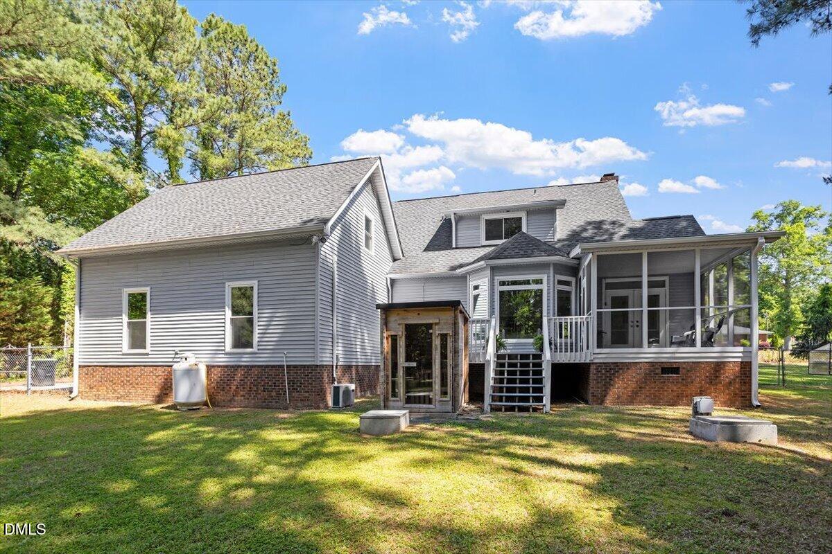 7505 Penny Road Raleigh, NC 27606 - Photo 4 of 35 a view of a house with a yard and sitting area