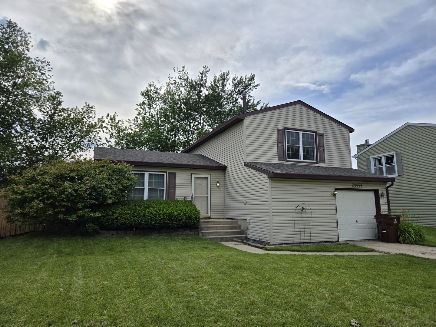 a view of a house with a yard and a garden
