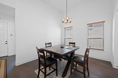 a view of a dining room with furniture and chandelier