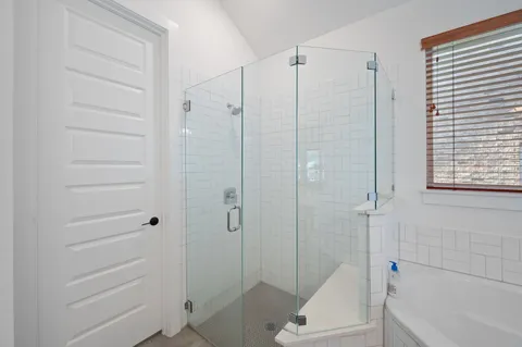 a bathroom with a sink a toilet a shower and a mirror