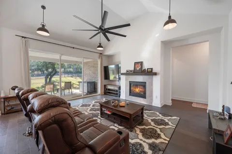 a kitchen with stainless steel appliances granite countertop a table chairs sink refrigerator and microwave