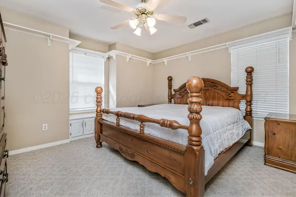 a bedroom with a bed and a lamp