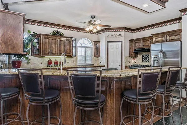 a kitchen with a table chairs sink and cabinets