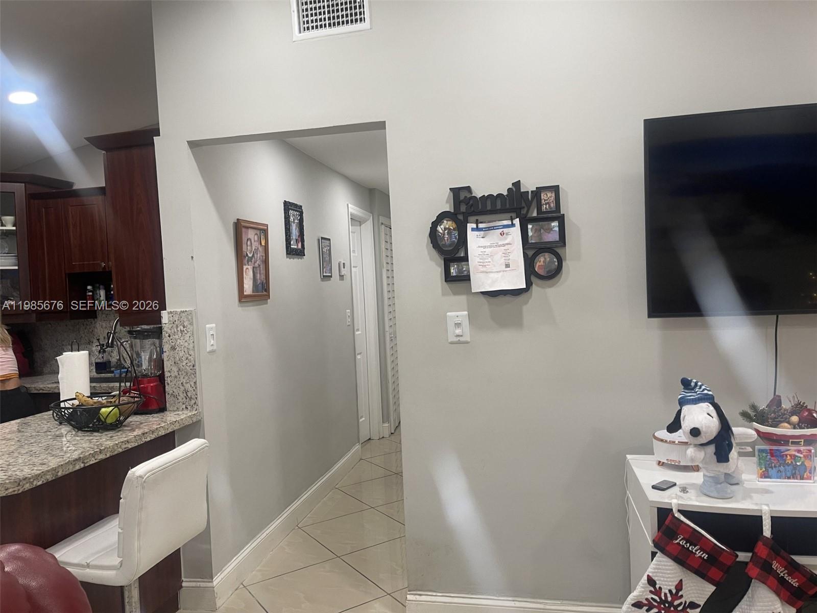 3115 Northwest 86th Street Miami, FL 33147 - Photo 3 of 4 a room with furniture and flat screen tv