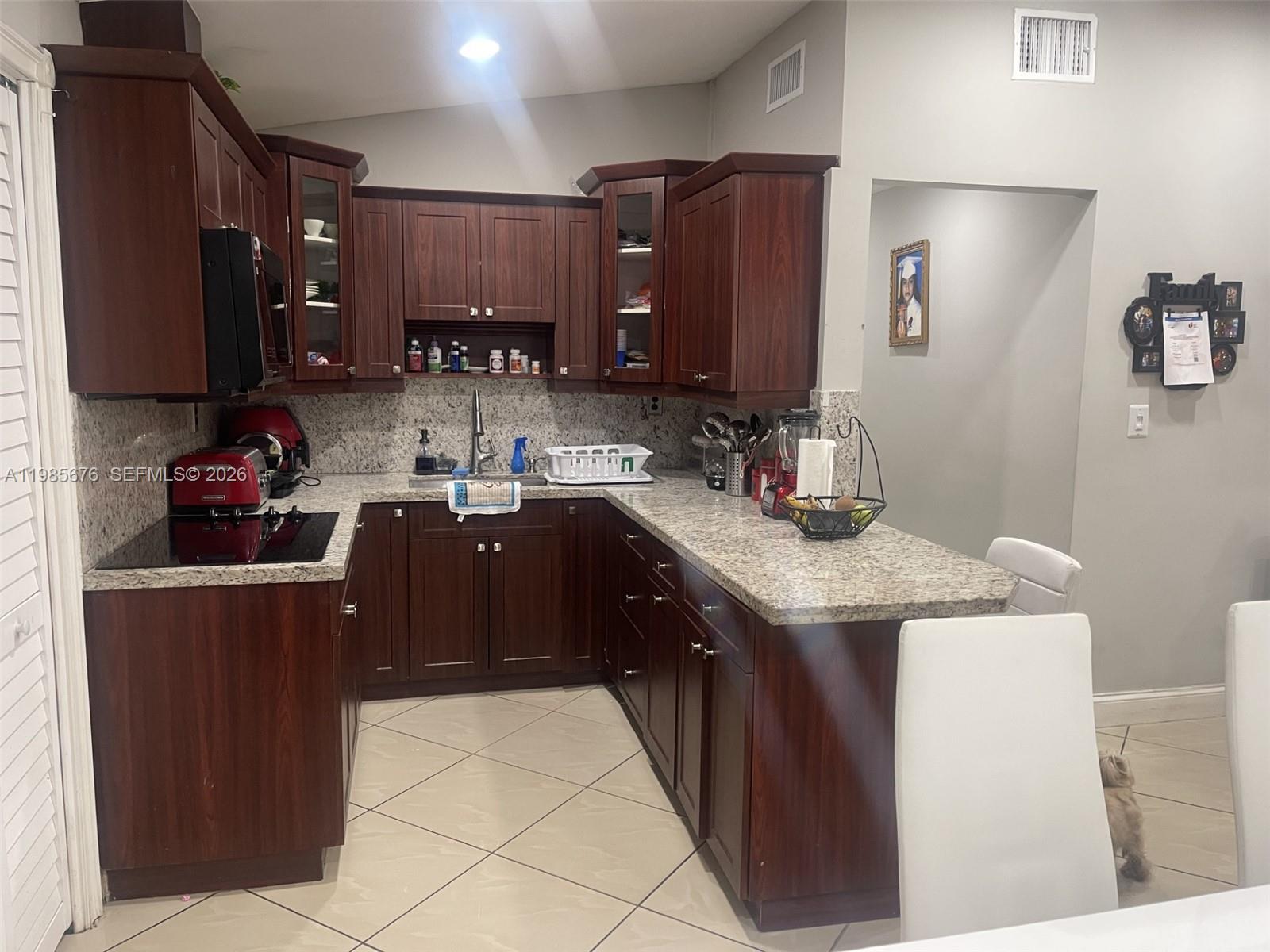 3115 Northwest 86th Street Miami, FL 33147 - Photo 4 of 4 a kitchen with a sink refrigerator and microwave