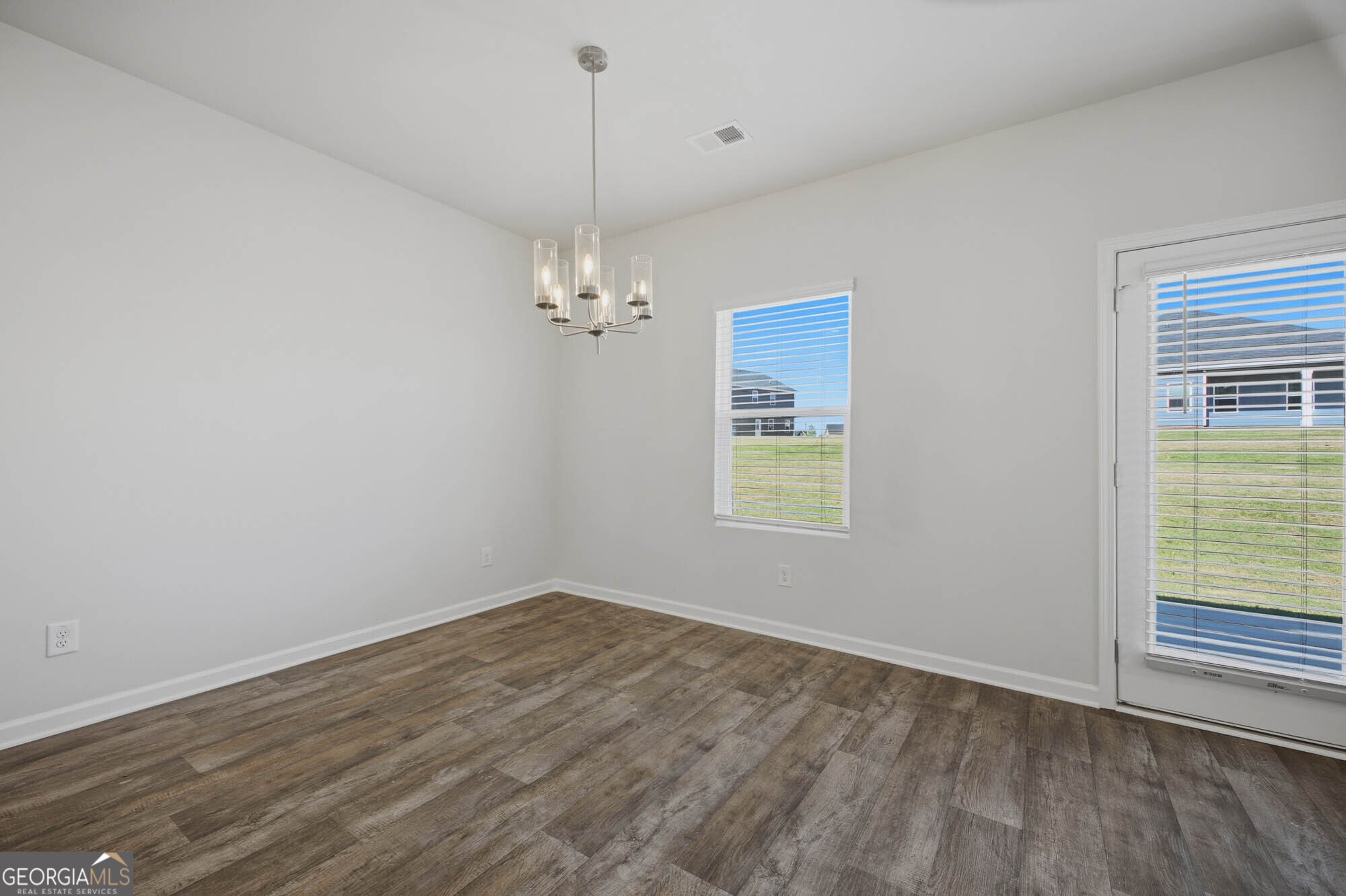 309 Rusty Plow Lane Perry, GA 31069 - Photo 22 of 34 wooden floor in an empty room with a window