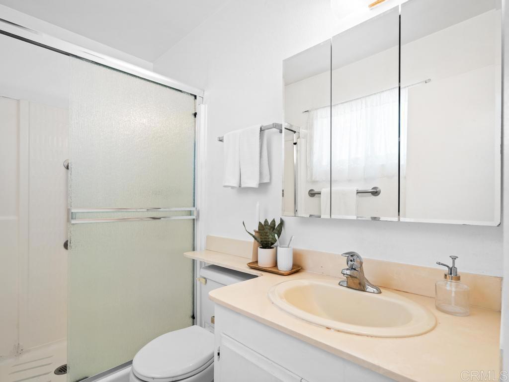 10020 Stanley Court Santee, CA 92071 - Photo 11 of 27 a bathroom with a sink a toilet and shower
