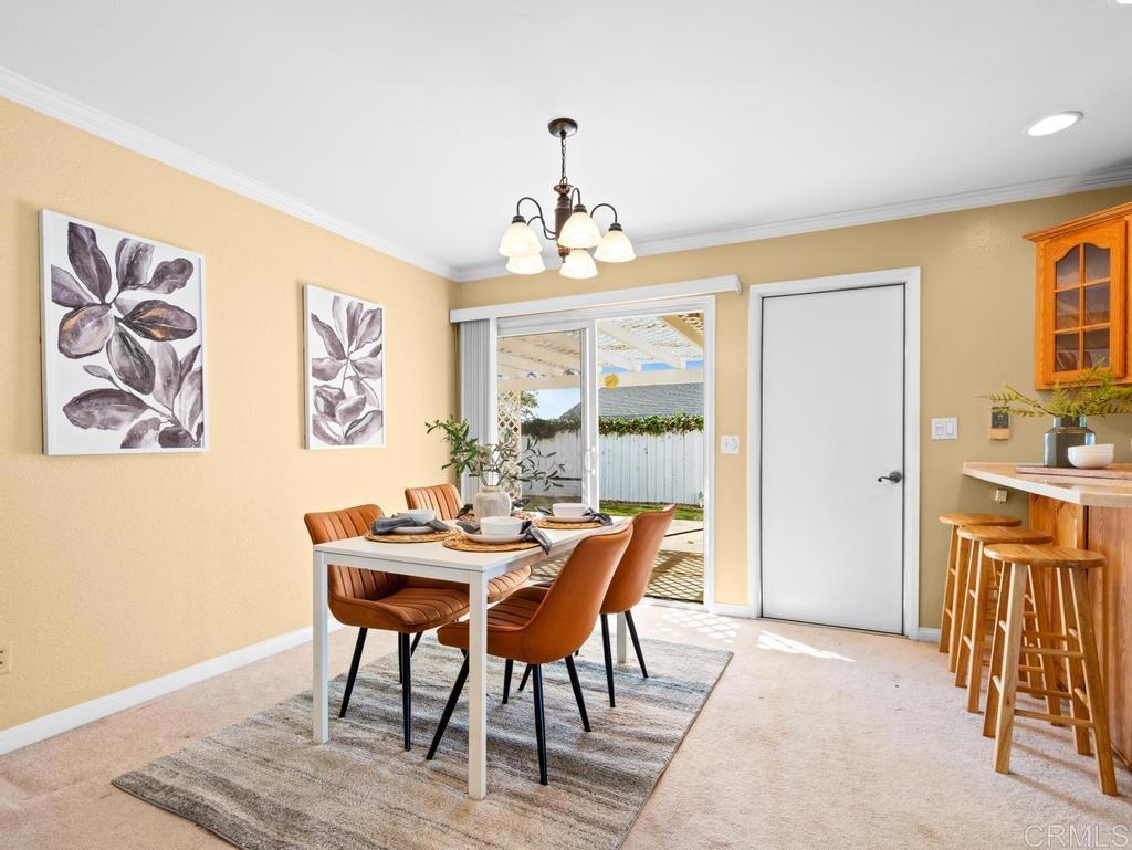 10020 Stanley Court Santee, CA 92071 - Photo 6 of 27 a dining room with furniture a chandelier and wooden floor