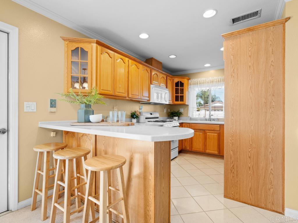 10020 Stanley Court Santee, CA 92071 - Photo 7 of 27 a kitchen with a sink and cabinets