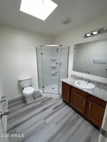a spacious bathroom with a granite countertop sink toilet and shower