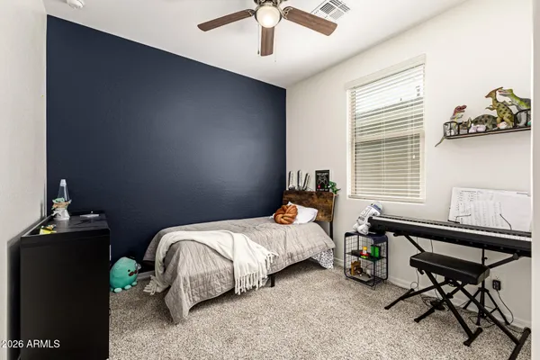 a bedroom with a bed and a window