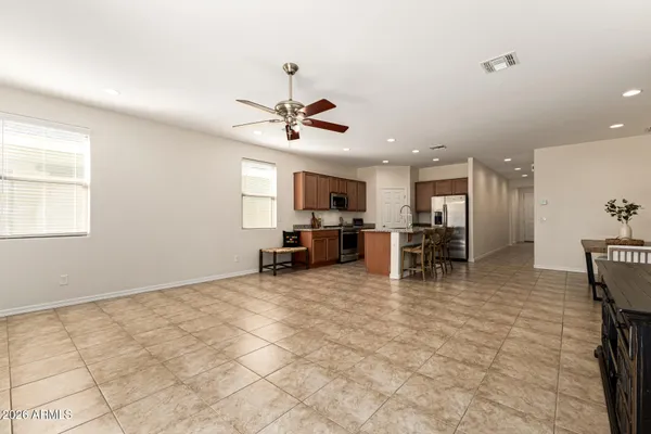 a view of a livingroom with furniture and a ceiling fan
