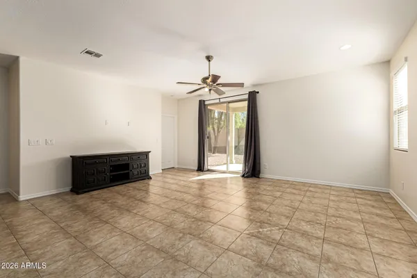 en empty room with windows and brick walls