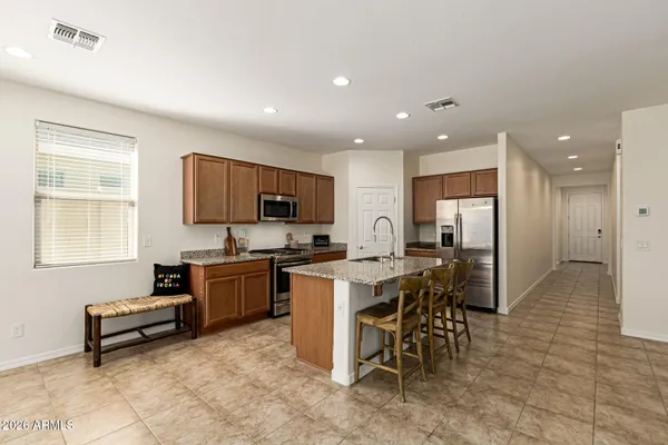 a kitchen with furniture a refrigerator and a view of living room