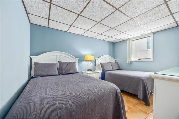 a bedroom with a large bed and a dresser