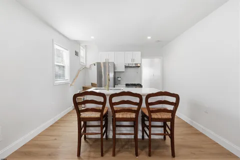 a dining room with furniture and wooden floor