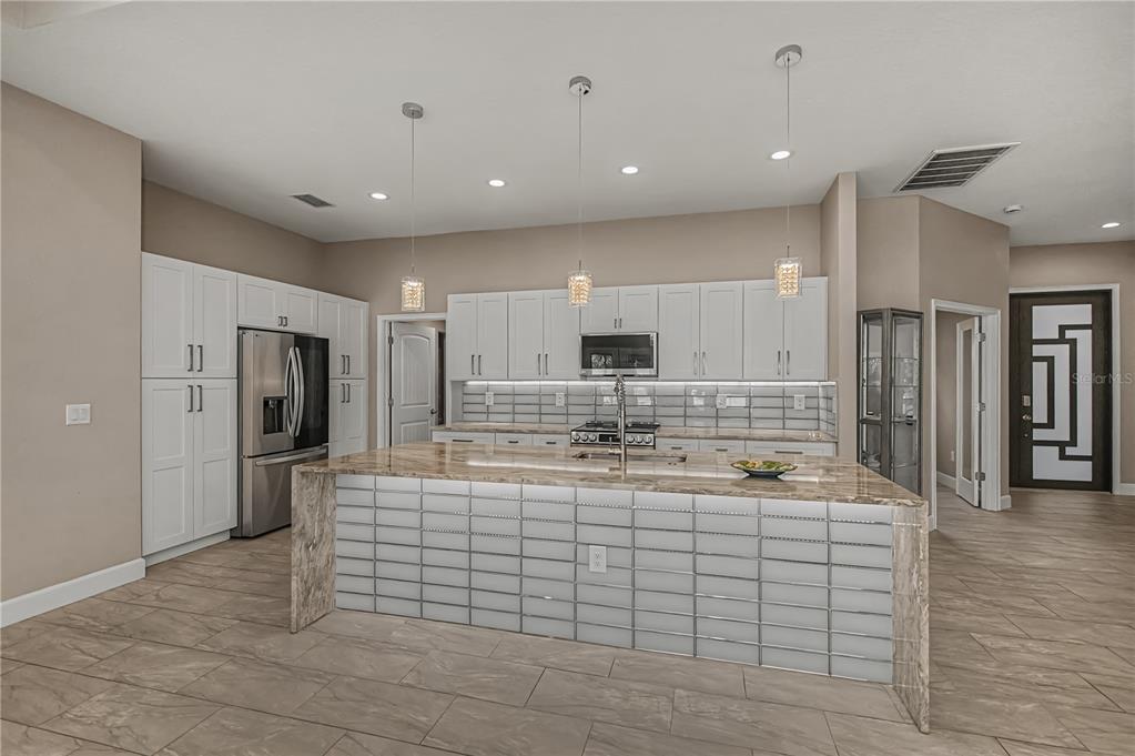 159 April Road Rotonda West, FL 33947 - Photo 19 of 73 a large white kitchen with a large window