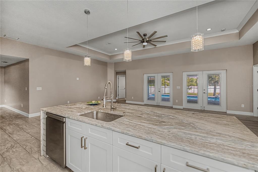 159 April Road Rotonda West, FL 33947 - Photo 20 of 73 a view with granite countertop kitchen island a sink stainless steel appliances and living room view