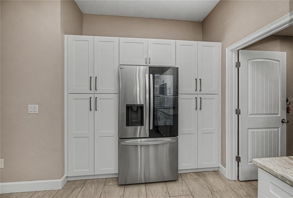 159 April Road Rotonda West, FL 33947 - Photo 22 of 73 a kitchen with stainless steel appliances a refrigerator and cabinets