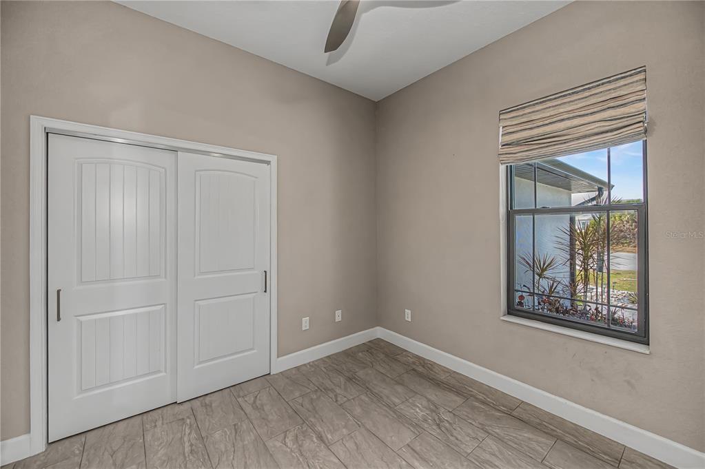 159 April Road Rotonda West, FL 33947 - Photo 27 of 73 an empty room with windows and closet