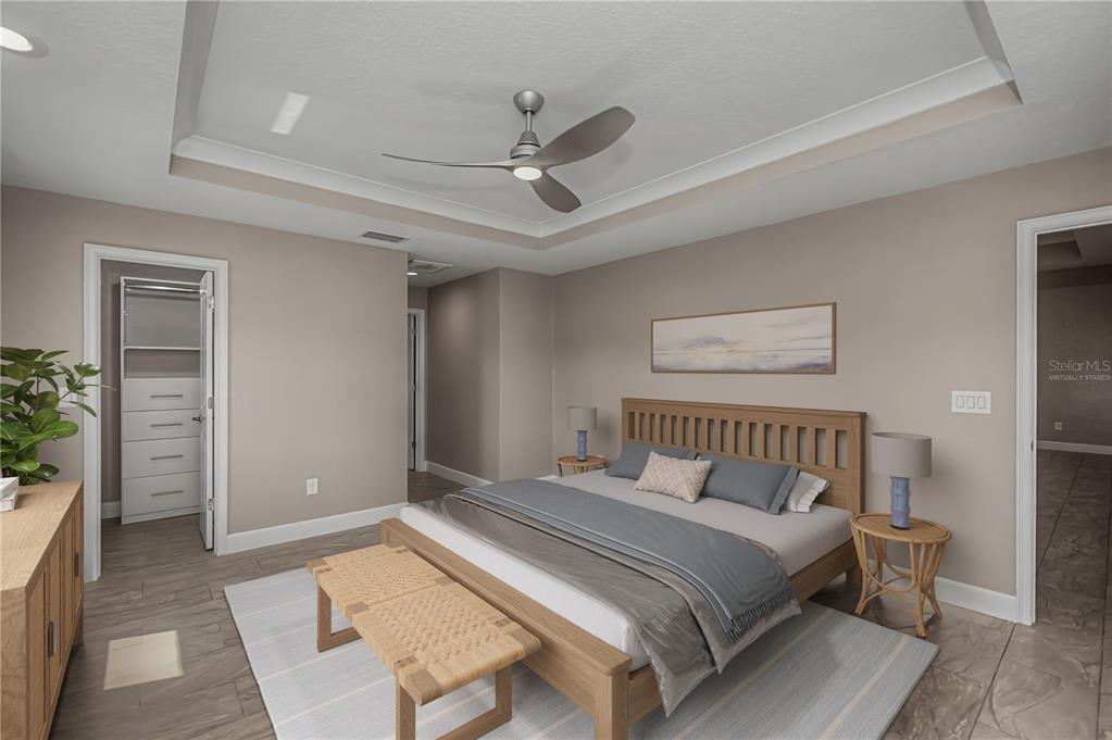 159 April Road Rotonda West, FL 33947 - Photo 28 of 73 a bedroom with a bed and a potted plant