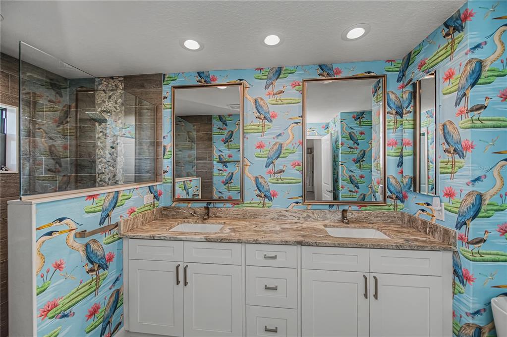 159 April Road Rotonda West, FL 33947 - Photo 34 of 73 a bathroom with a sink a vanity and a window